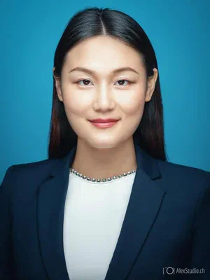 Crisp professional profile of a composed professional in a navy blazer and white embellished top, centered against a vibrant turquoise studio background.