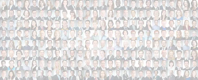 A broad mosaic of diverse professional headshots presents men and women in business attire against softly lit neutral studio backgrounds.