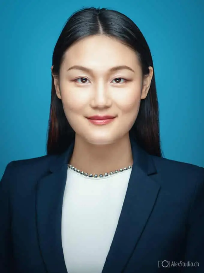 Woman's portrait taken by Photographer in Geneva in Professional Studio for CV, Resume or LinkedIn on blue Background by Photographer Alex Petrenko