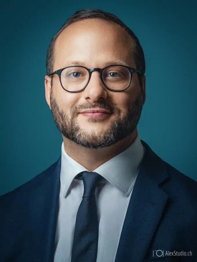 Man's portrait taken by Photographer in Geneva in Professional Studio for CV, Resume or LinkedIn on blue Background by Photographer Alex Petrenko